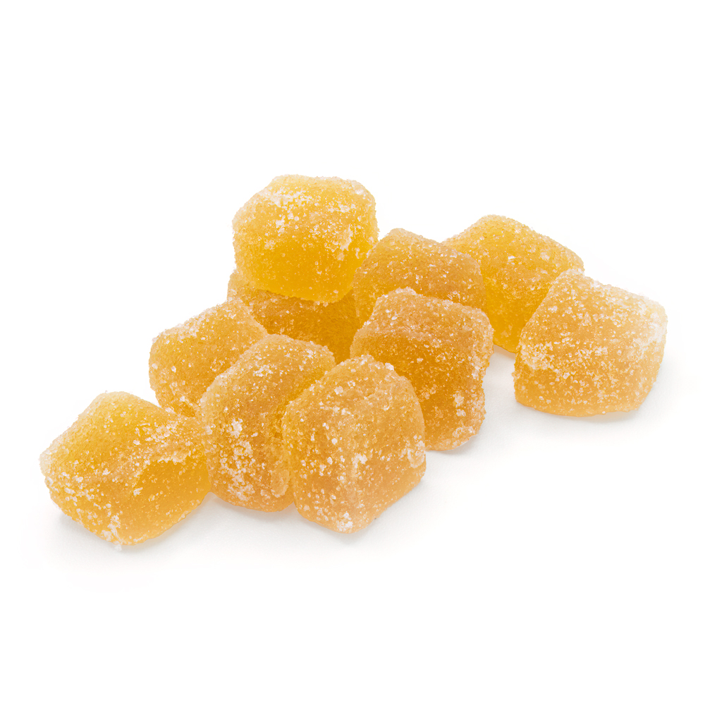 close up of a stack of 8 cannabis infused lemon fruit chews on a white background.