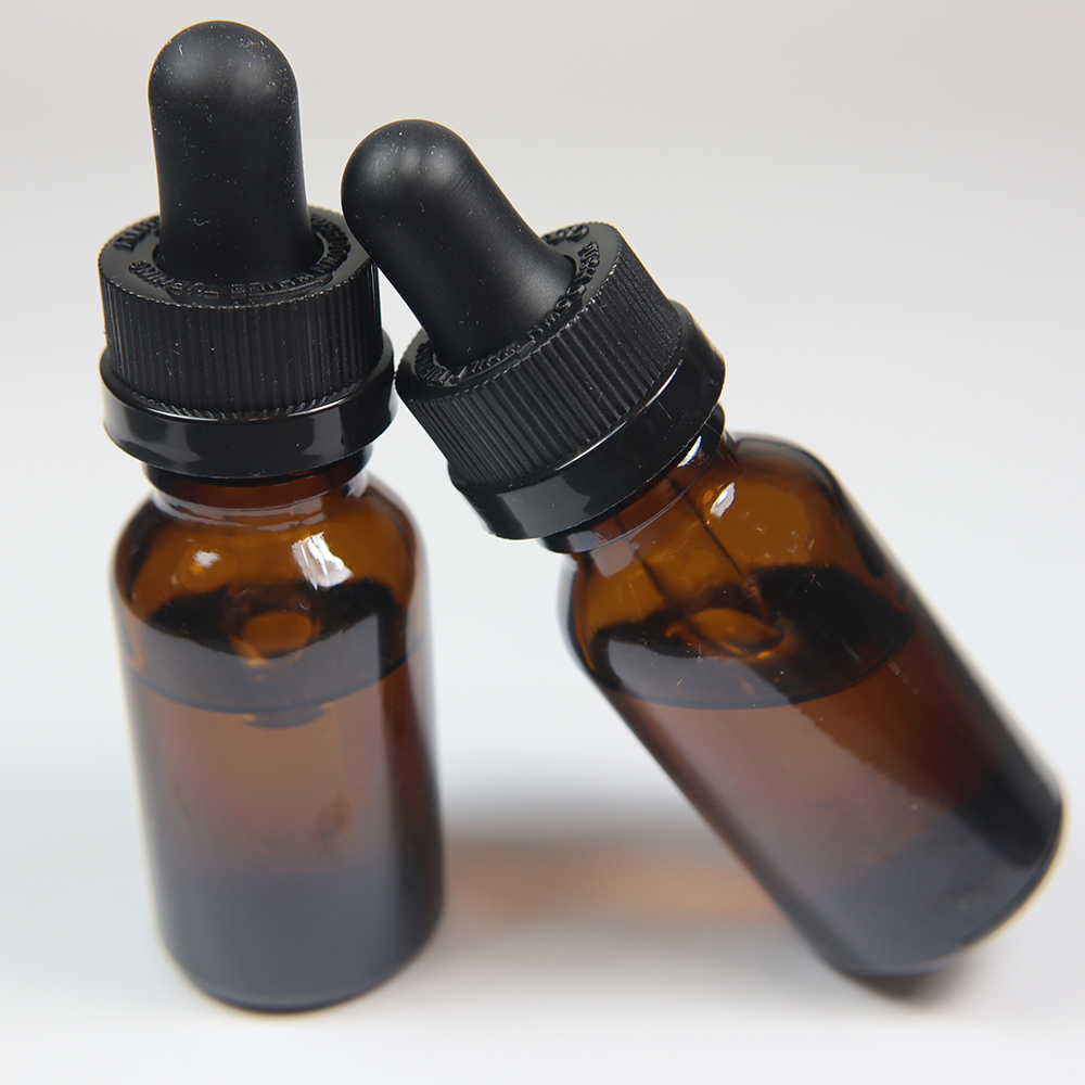Two tincture bottles against a white background.