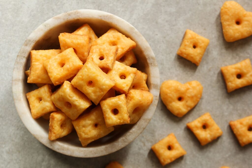 Bright orange homemade cheese crackers in a bowl