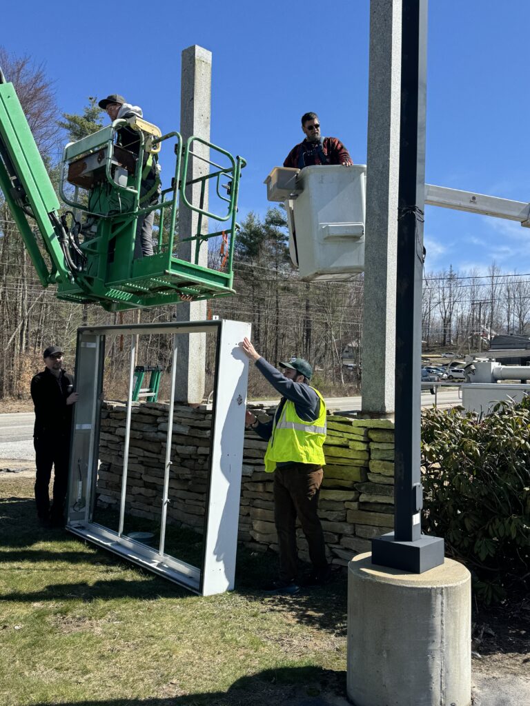 preparing to install the new sign in Chichester